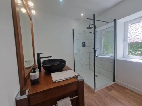 a bathroom with a sink and a glass shower at Gite De Sandra #Confort in Olby