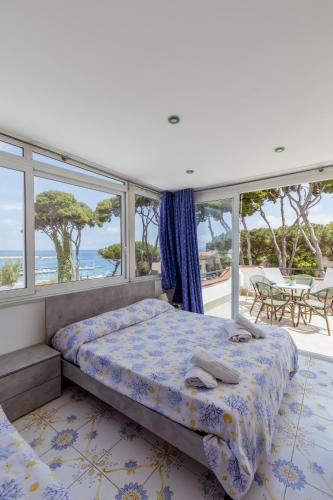 a bedroom with a bed and a view of the ocean at Casamicciola Rooms in Casamicciola Terme