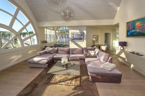 a living room with a couch and a table at Strandschloss Binz - Penthouse "Royal Beach" mit Sauna, Kamin, Terrasse, Meerblick in Binz