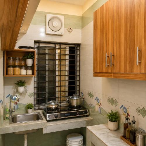a kitchen with a stove and a sink at Jannat Residential Hotel in Atgaon