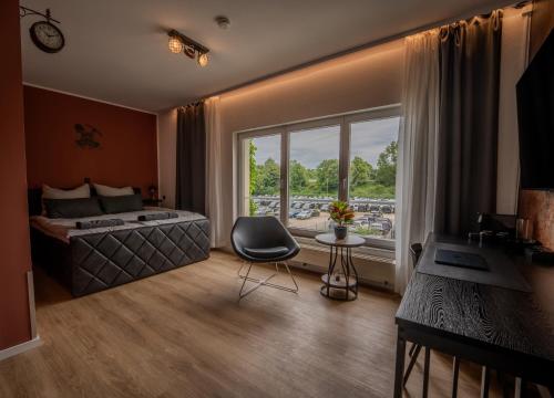 a bedroom with a bed and a large window at Industrial Design Studios - Lohnhalle Essen in Essen