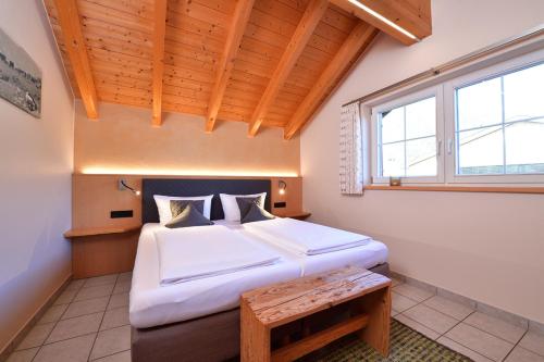 a bedroom with a large bed and a window at Haus im Wäldle in Balderschwang