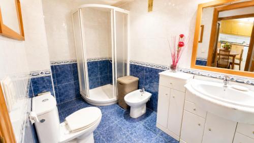 a bathroom with a toilet and a shower and a sink at Tirolina by Edeal HOMES in Denia