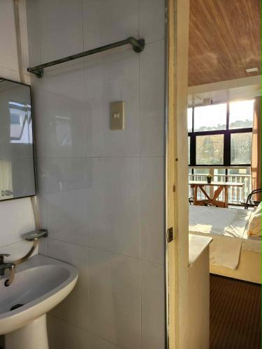 a bathroom with a sink and a mirror at R Hotel Centro and Restaurant in Marinduque