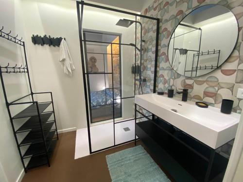 a bathroom with a sink and a mirror at Cavour 106 Apartment in Palermo
