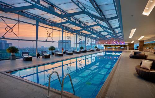 a large swimming pool in a building with a view at JW Marriott Hotel Hanoi in Hanoi
