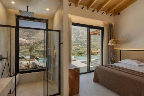 a bedroom with a bed and a sliding glass door at Nekyra Villa in Zóla