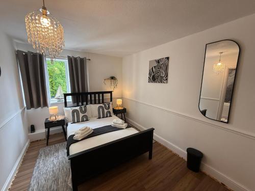 a bedroom with a bed and a large mirror at Grande Italia Rooms Comfort Italian Hospitality 4 in Ebley