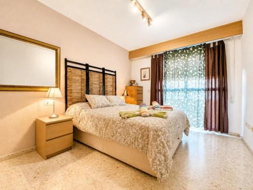 a bedroom with a large bed and a window at Tirolina by Edeal HOMES in Denia