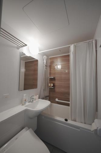 a bathroom with a sink and a toilet and a shower at 日和のすみか in Ichihara