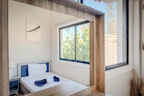 a small room with a bed and a window at Merika Complex 1 in Perivolia