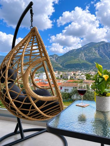 a glass of wine sits on a table on a balcony at Comfy Vista Apartment in Kalamata