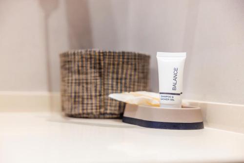 a container of sunscreen sitting on a bathroom counter at Sunrise Qeparo in Qeparo