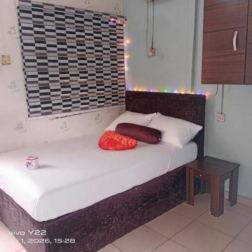 ein Bett mit zwei Kissen darauf in einem Zimmer in der Unterkunft Prince Ator Hotel in Ikeja