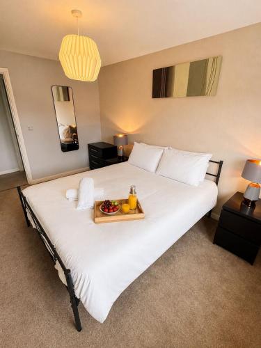 a large white bed with a tray of fruit on it at 2BR House By Cozy Quarters Property Management Contractors Accommodation Spennymoor With Parking in Spennymoor