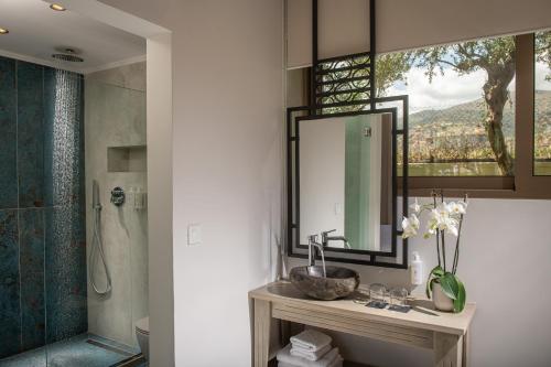 a bathroom with a sink and a mirror at Parthenis Hotel & Suites in Malia