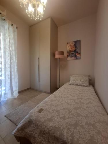 a bedroom with a bed and a lamp and a window at SuiteViewPoros-Luxury Apartment in Galatas in Galatas