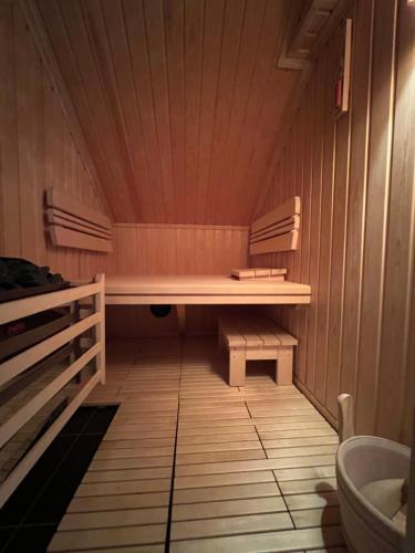 a sauna with a wooden bench in a room at U Izhu with Private Pool, Sauna & BBQ in Prevala