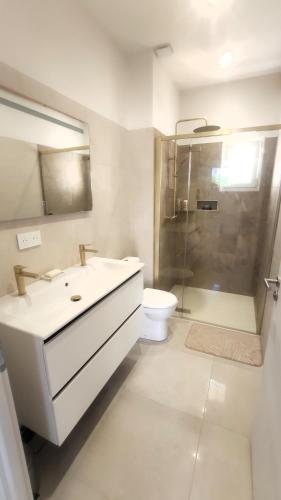 a bathroom with a sink and a shower and a toilet at Pause au coeur des Côtes-Rôtie in Ampuis