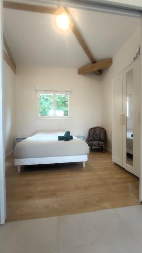a white bedroom with a bed and a window at Pause au coeur des Côtes-Rôtie in Ampuis