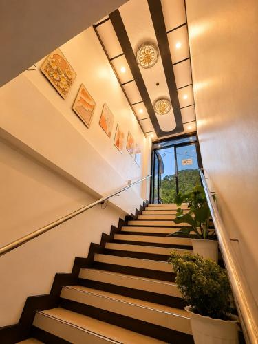 a staircase in a building with some plants at Jace's Travellers Inn El Nido near Corong Corong Beach in El Nido