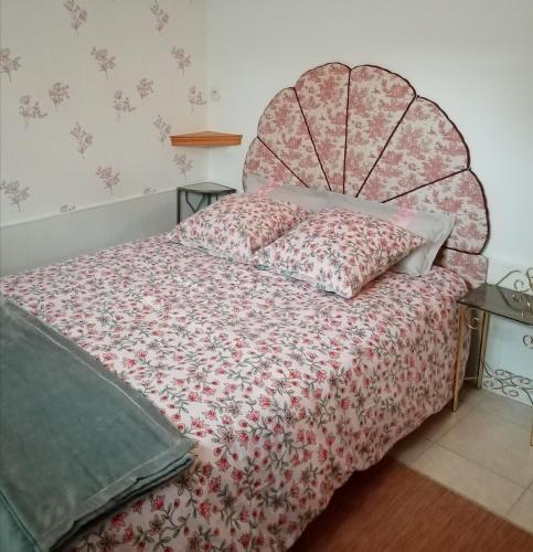 a bedroom with a bed with a red bedspread at Les Jeux du Moulin in Nouans-les-Fontaines