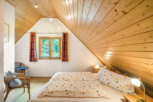 a bed in a room with a wooden ceiling at Jäckleshof in Sankt Georgen im Schwarzwald