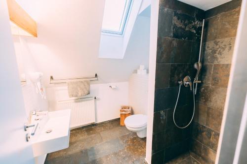 a bathroom with a toilet and a sink at Stadthaus - Gut Hügle Collection in Ravensburg