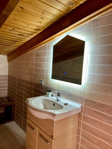 a bathroom with a sink and a mirror at Aegean Sea Rooms in Chios