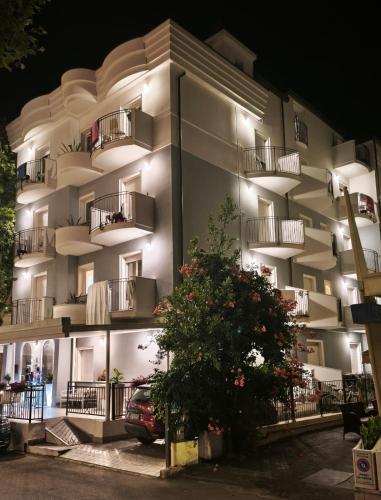 a building with balconies and a car parked in front at Residence Mareo in Riccione