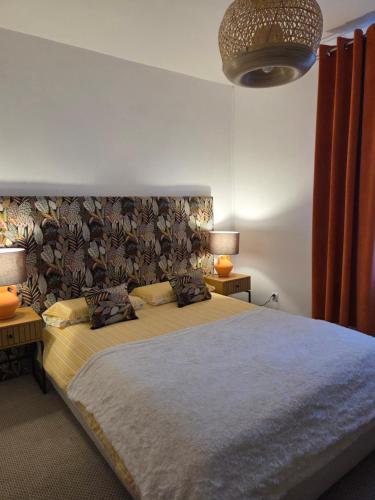 a bedroom with a large bed with two tables and two lamps at Apartament Lipowa Centrum in Mrągowo