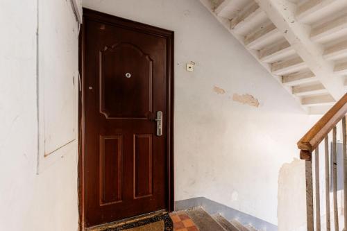 a wooden door in a room with stairs at Marie` Apartment in Salme