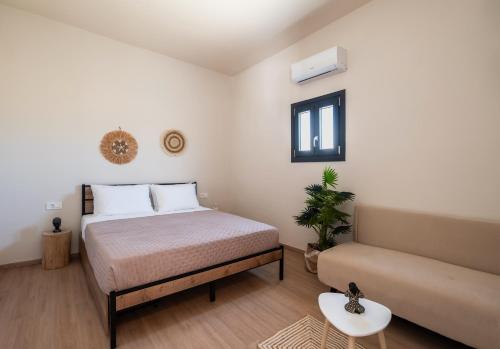 a bedroom with a bed and a couch at Ornos Collection - by Hospirit in Ornos