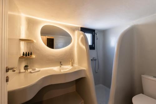 a bathroom with a sink and a mirror at Ornos Collection - by Hospirit in Ornos