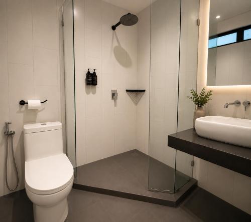 a bathroom with a toilet and a sink at the youniQ Hotel, KLIA T1, KLIA T2 in Sepang