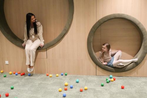 two women are sitting in circular mirrors in a room at PINEA Resort in Pobierowo