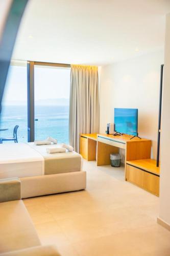 a hotel room with two beds and a window at Sunrise Qeparo in Qeparo