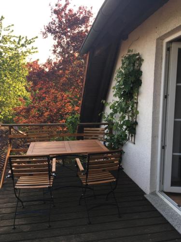 a wooden table and chairs on a deck at Im Grünen in Klein Trebbow