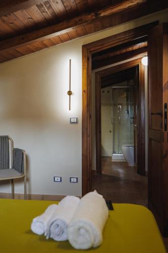 a bedroom with a bed with towels on it at Casale Incanto in Terracina