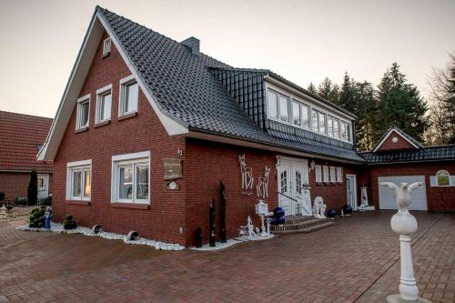 a red brick house with graffiti on the side of it at Ferienwohnung Schoon, 85042 in Ostrhauderfehn