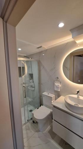 a bathroom with a toilet and a sink and a shower at Stone house 1 in Líthion