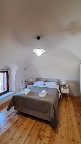 a bedroom with a large bed and a ceiling at Stone house 1 in Líthion