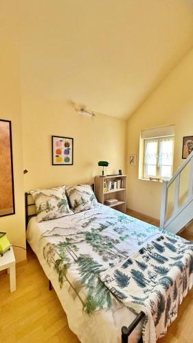 a bedroom with a large bed in a room at L Ecureuil Ludique in Beaumont-le-Roger