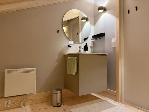 a bathroom with a sink and a mirror at Sommarbukt Nordlys - Private Arctic Retreat near Tromsø in Tromsø