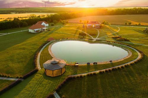 an aerial view of a pond in a field at Chalets Franciska Major, Pro Village in Sopronkövesd