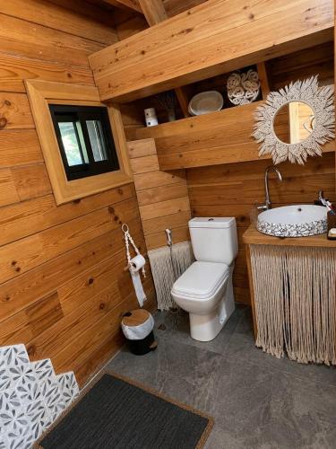 a wooden bathroom with a toilet and a sink at M Place in Shārūn