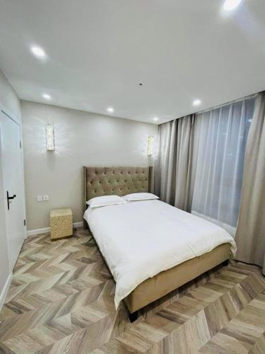 a bedroom with a large bed and a large window at Royal Villa in Yoliin Hural