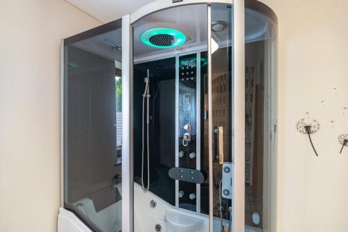 a mirror with a blue light in a bathroom at Eifel Dream Zingsheld in Fleringen