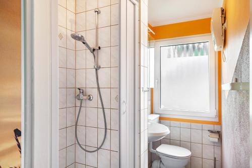 a bathroom with a shower with a toilet and a window at Ferienhaus 257 in Zadelsdorf