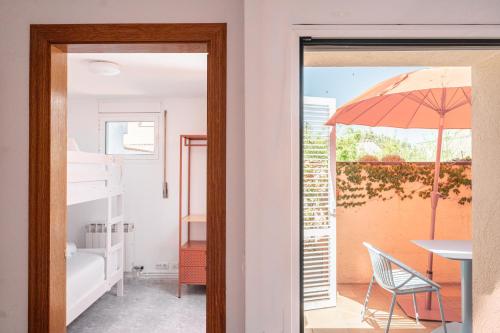 a door leading to a room with a chair and an umbrella at Majordoms Ponent in Banyoles